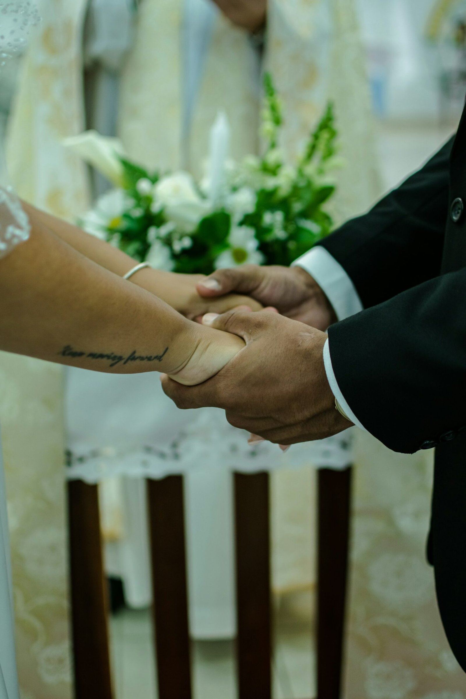 Bride and groom holding hands during a wedding ceremony