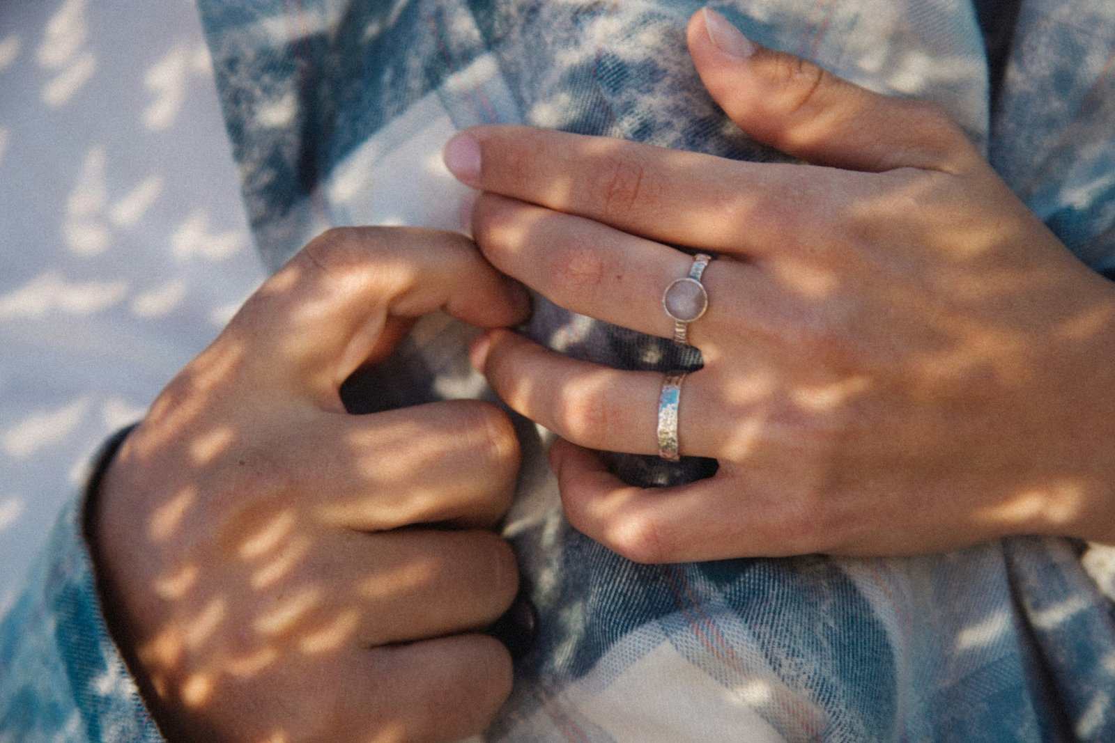 Close-up of a couples hands showing their wedding rings