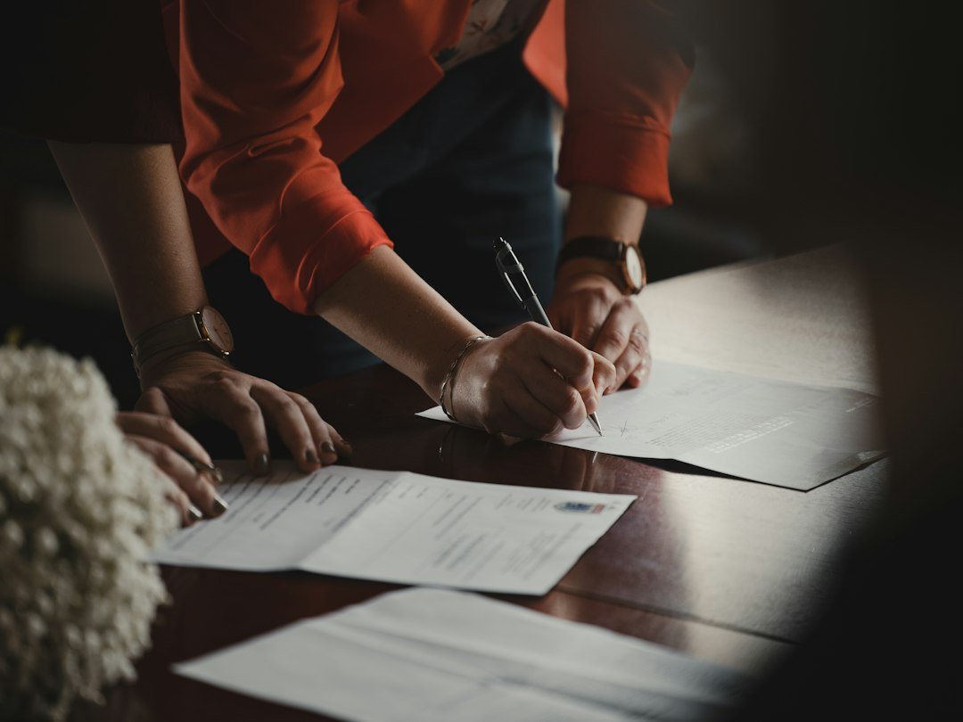 Couple signing marriage license paperwork